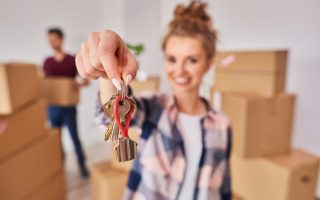 woman-s-hand-showing-keys-from-new-apartment