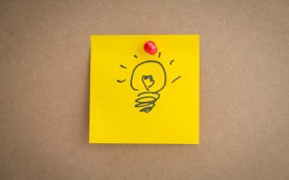 Sticky note with idae bulb on board